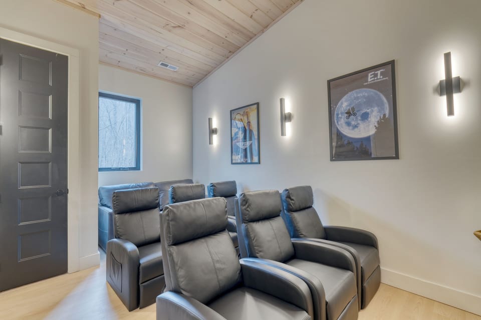 Movie room with theater-style seats.