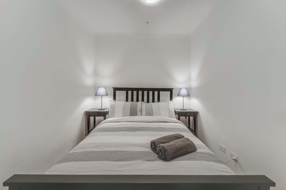 A cozy nook with a double sized bed & plush pillows.