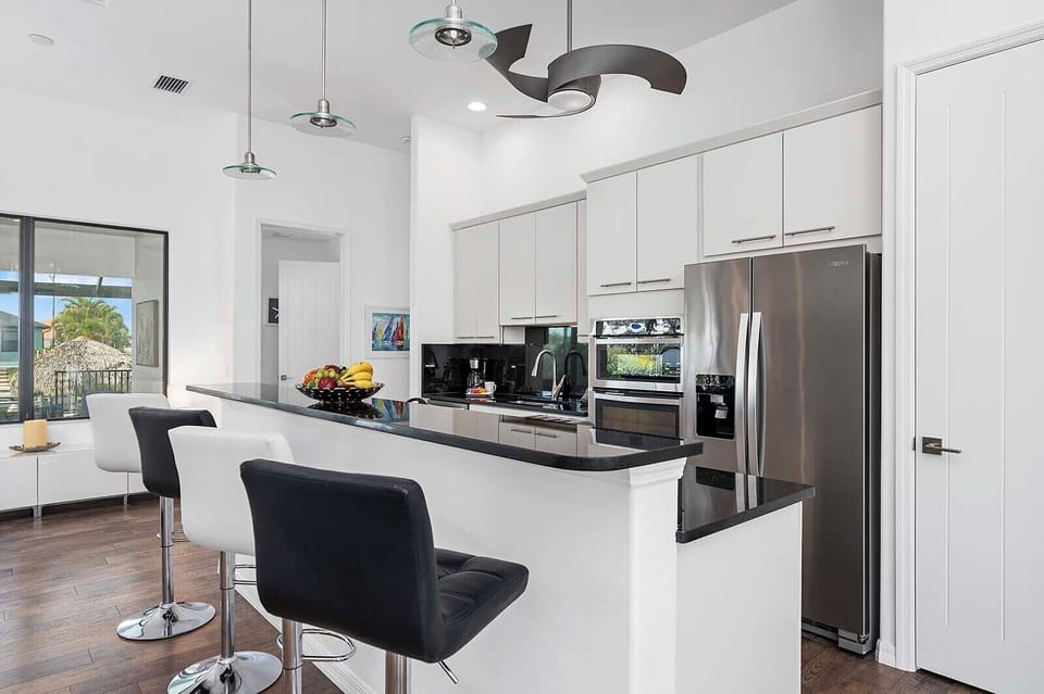 Kitchen Open to Main Living Room with Bar and Additional Seating Options