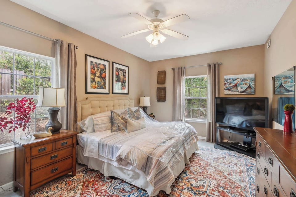 Cozy bedroom with spacious cabinet and tv for entertainment.