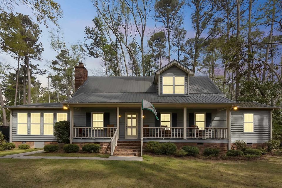 Exterior photo of the bigger house. Discover the charm of this home, surrounded by a spacious green yard—perfect for outdoor relaxation and activities!