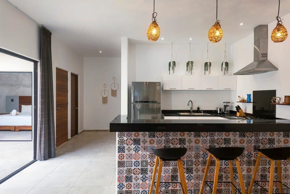 Modern and minimalist kitchen. Beautiful bar for enjoyment.