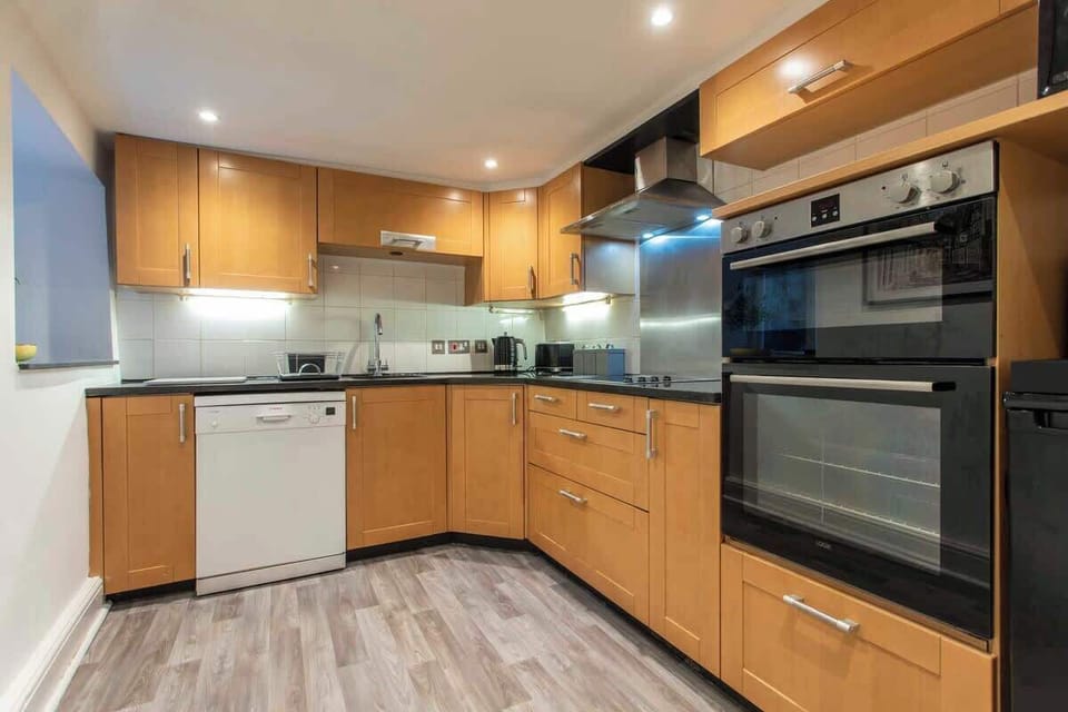 fully equipped kitchen with electric hob, fridge freezer, dishwasher and pod coffee machine. Washing machine and dryer are in the utility room.
