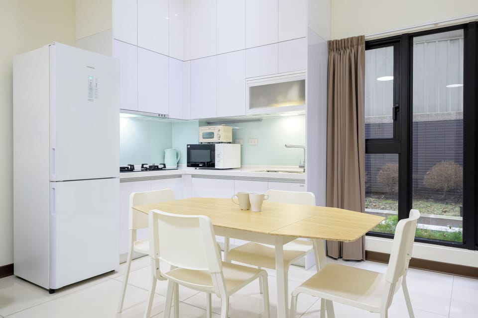Full kitchen with fridge, microwave, water kettle.