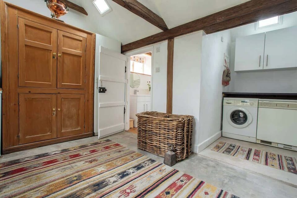 Utility room with washing machine and dryer. The second bathroom leads off from this room