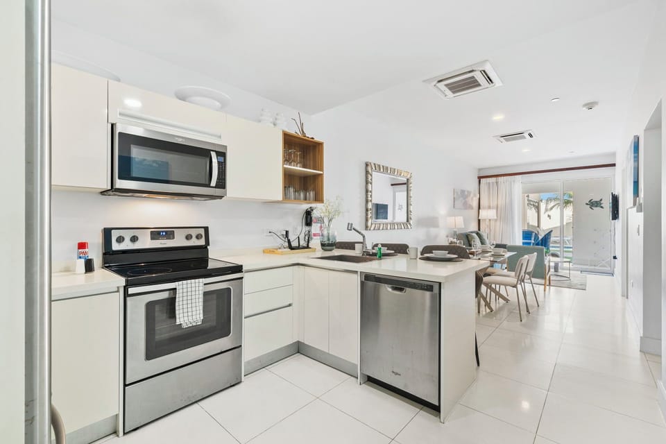 Modern kitchen with stainless steel appliances and extra counter space for meal prep - Thoughtfully designed with plenty of storage and a stylish, open layout - Perfect for cooking up your favorite dishes while enjoying a home like atmosphere