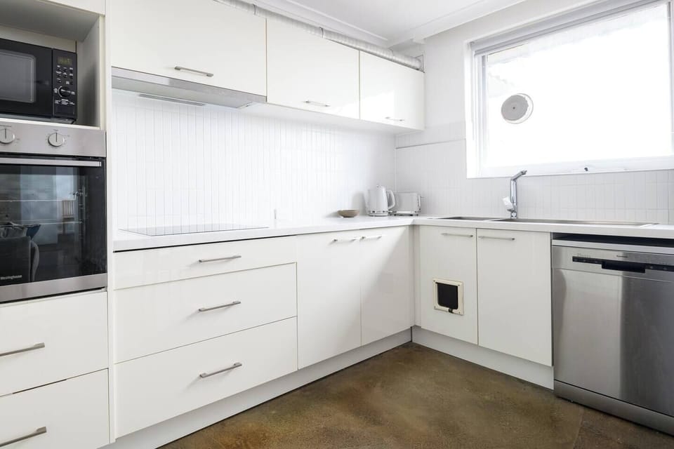 Cleaning up is painless with a large dishwasher and a double sink. Plenty of cabinet storage is available and cutlery, crockery and wine glasses are provided.
