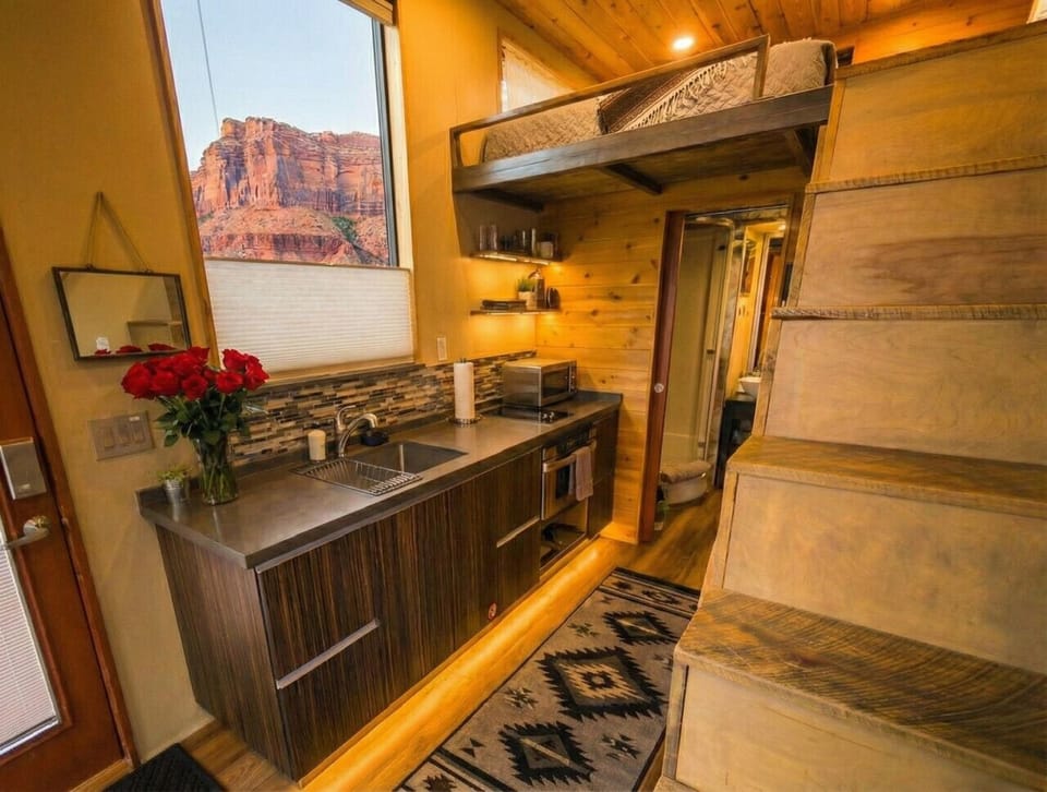 Compact kitchen with a red rock view right above the sink.