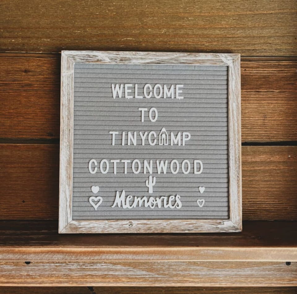 A handmade welcome sign greets you at Tiny Camp Cottonwood.
