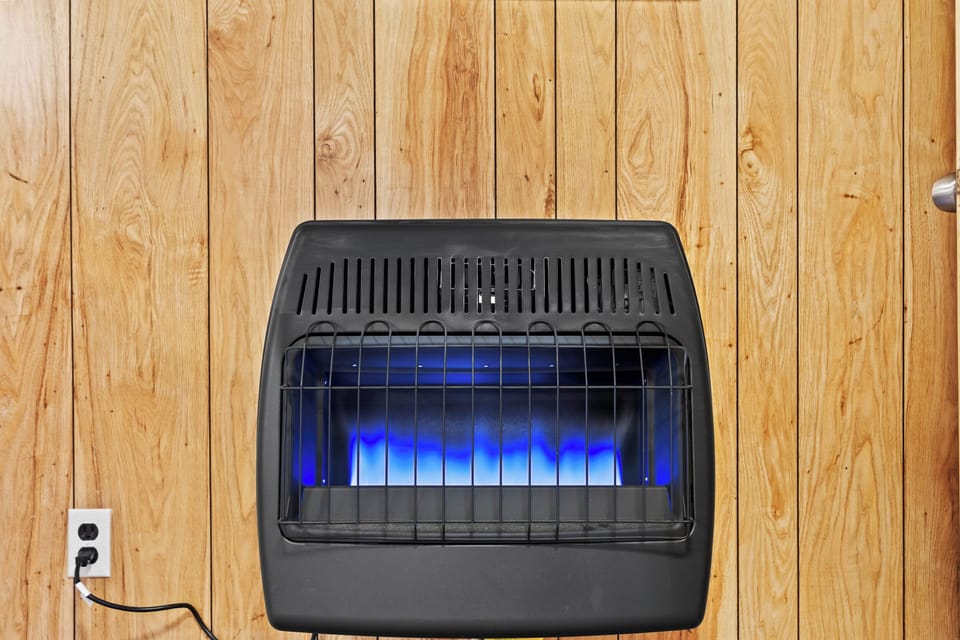 Propane wall heater is thermostat controlled.