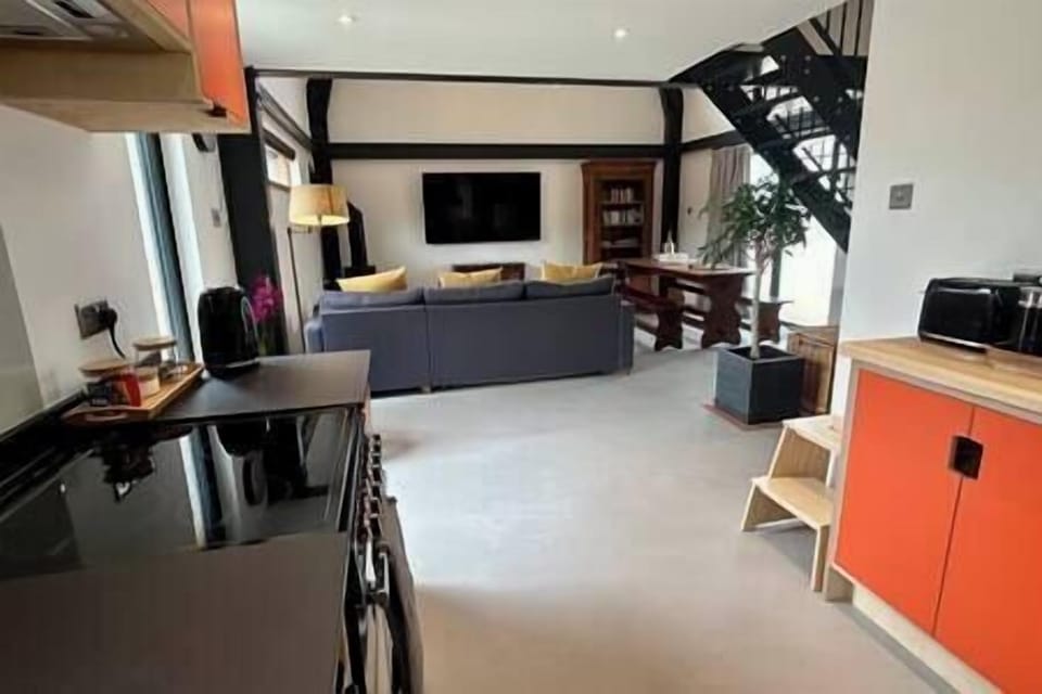 Double height living area with double sofa bed and large dinging table (3)