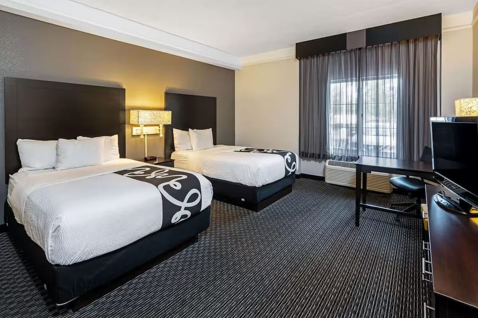 Relax together in a bright double-bed room with cozy linens.