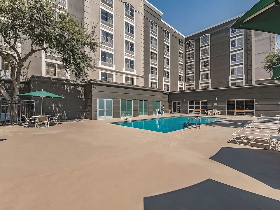 Dive into resort-style relaxation beside the sunlit pool deck.