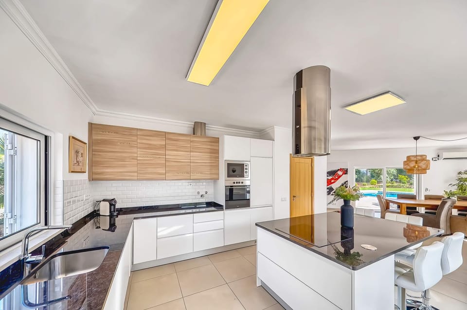 Large and open kitchen of Villa Larissa with kitchen island, fridge, oven, microwave and everything you need for a great holiday in the kitchen