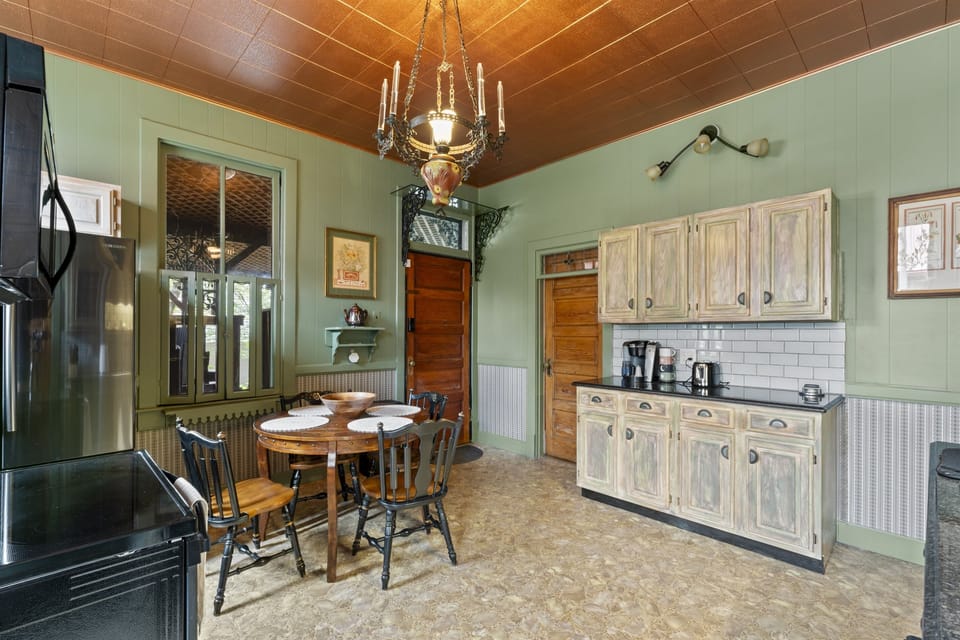 Enjoy casual meals or morning coffee at the kitchen table, featuring comfortable seating and a stylish setup.