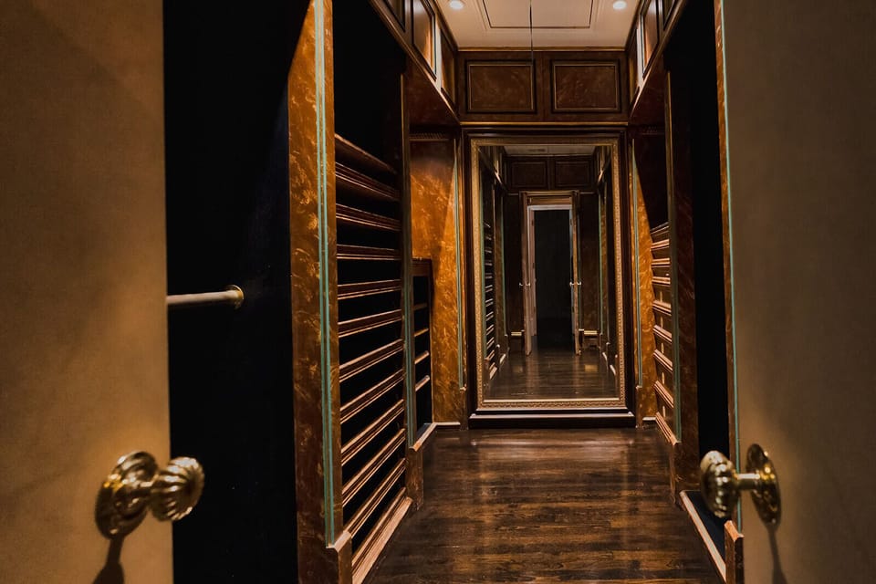 One of two walk-in closets of primary bedroom