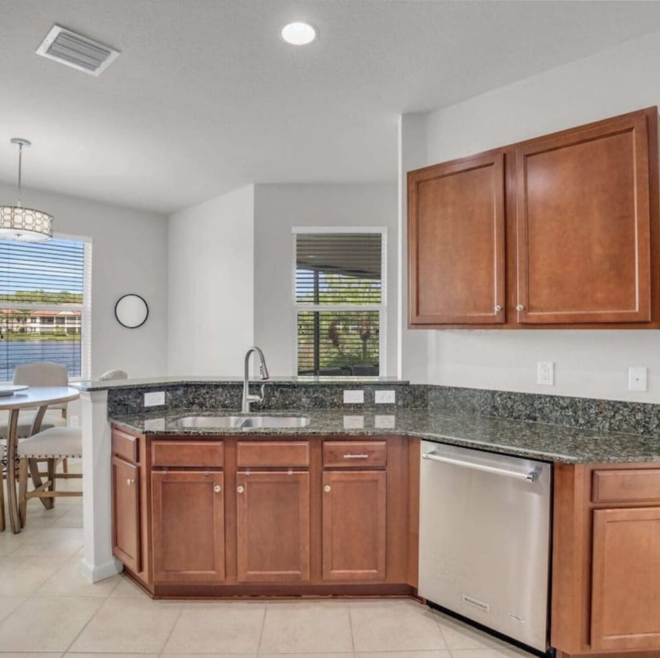 Fully equipped kitchen overlooks dining nook with water views.