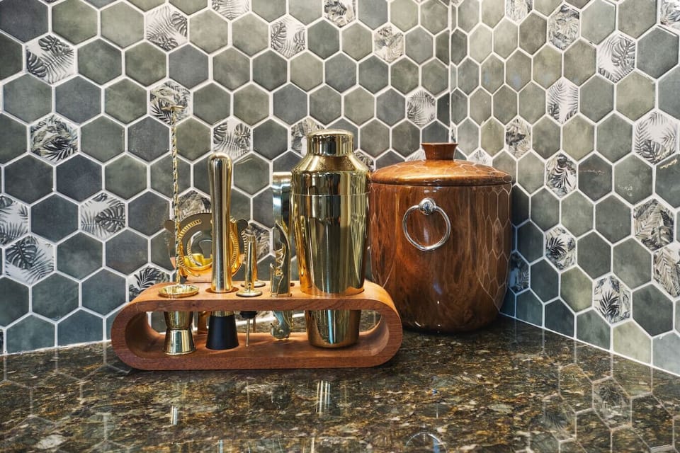 Fully equipped kitchen with all your cooking essentials, drip coffee maker + coffee. Dining table with seating for 2. This room opens up into the living room. Uniquestyle, wallpaper and decor all throughout the condo.