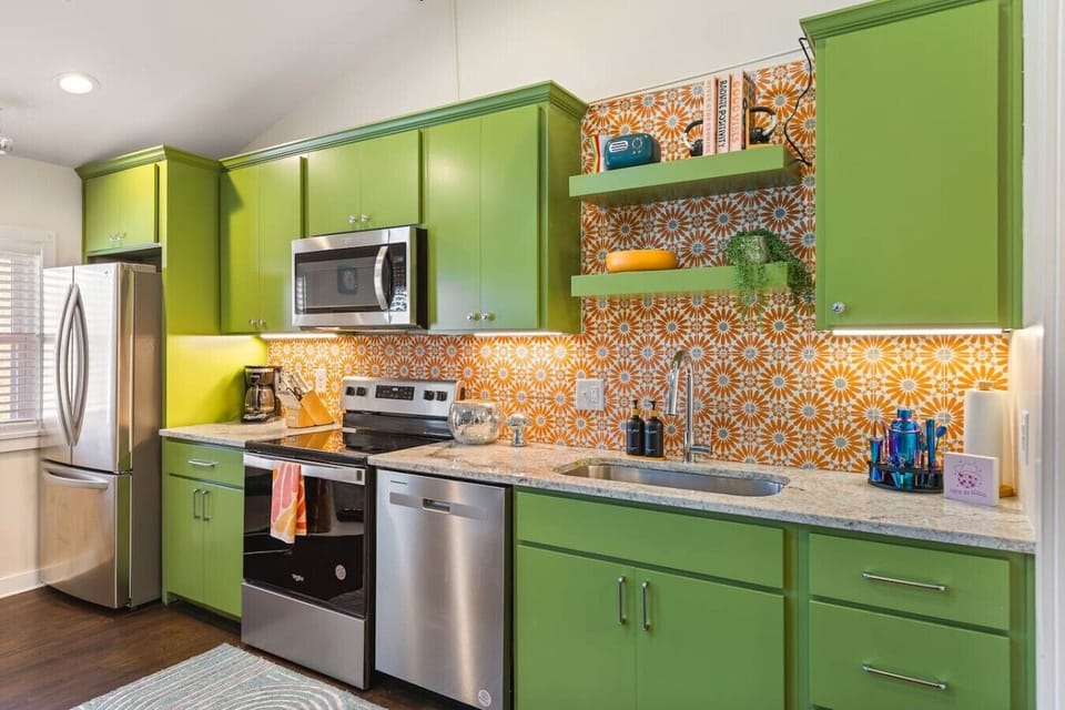 Fully equipped kitchen with all your cooking essentials, drip coffee maker + coffee. Dining table with seating for 2. This room opens up into the living room. Bold colors, bright lights and decor all throughout the condo.