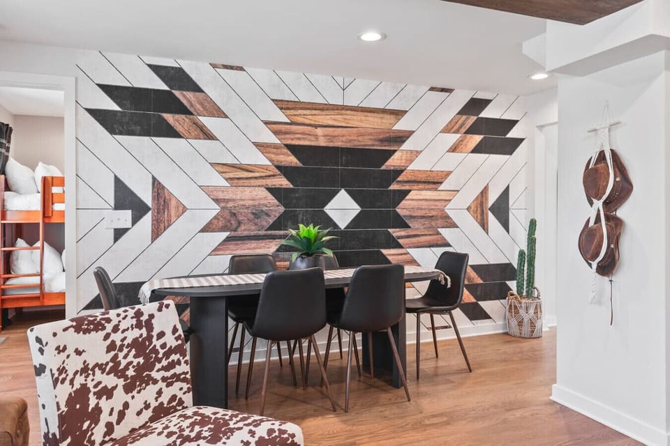 Dining table with seating for 6. This room opens up into the living room. Unique colors, wallpaper and decor all throughout the condo.
