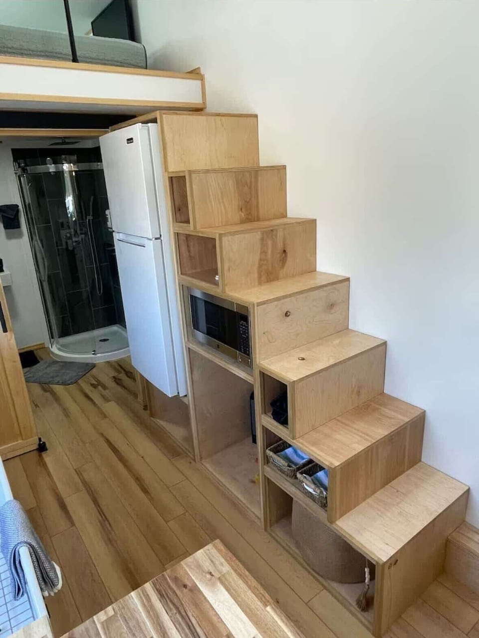 Ascend the modern wood staircase to your serene sleeping retreat above!