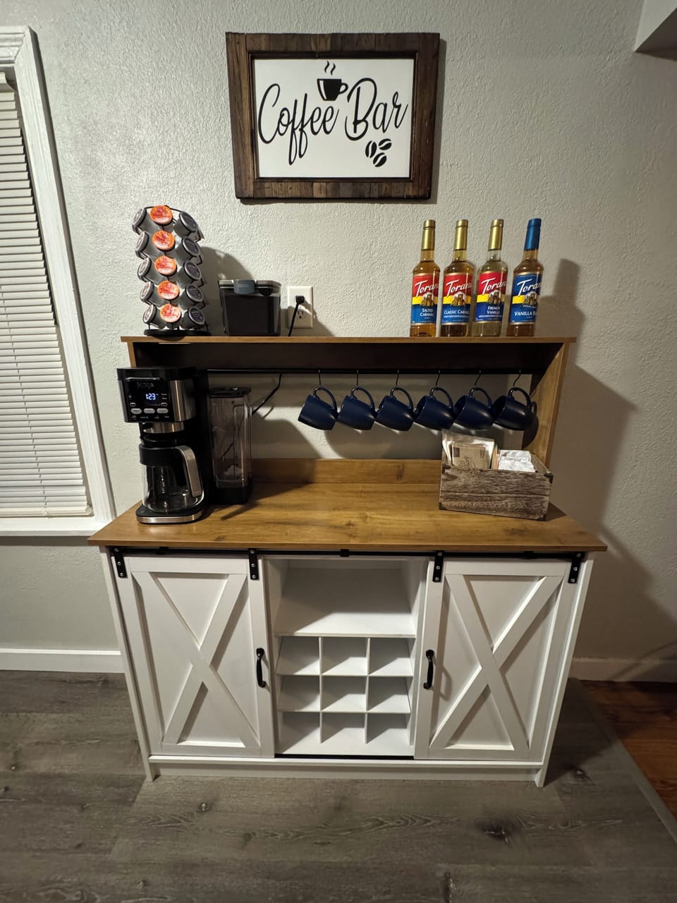 MAIN LEVEL, KITCHEN:  Open floor concept flows from Living Room into the Kitchen with  Deluxe Coffee Bar: Deluxe Dual Ninja Coffee maker with both single serve, K-cup coffee pods, or  make a pot  of your favorite grind, Special variety of coffee syrups,  Manual Coffee Grinder,  and a French Press for all the coffee connoisseurs.  Selected variety of organic tea bags.
