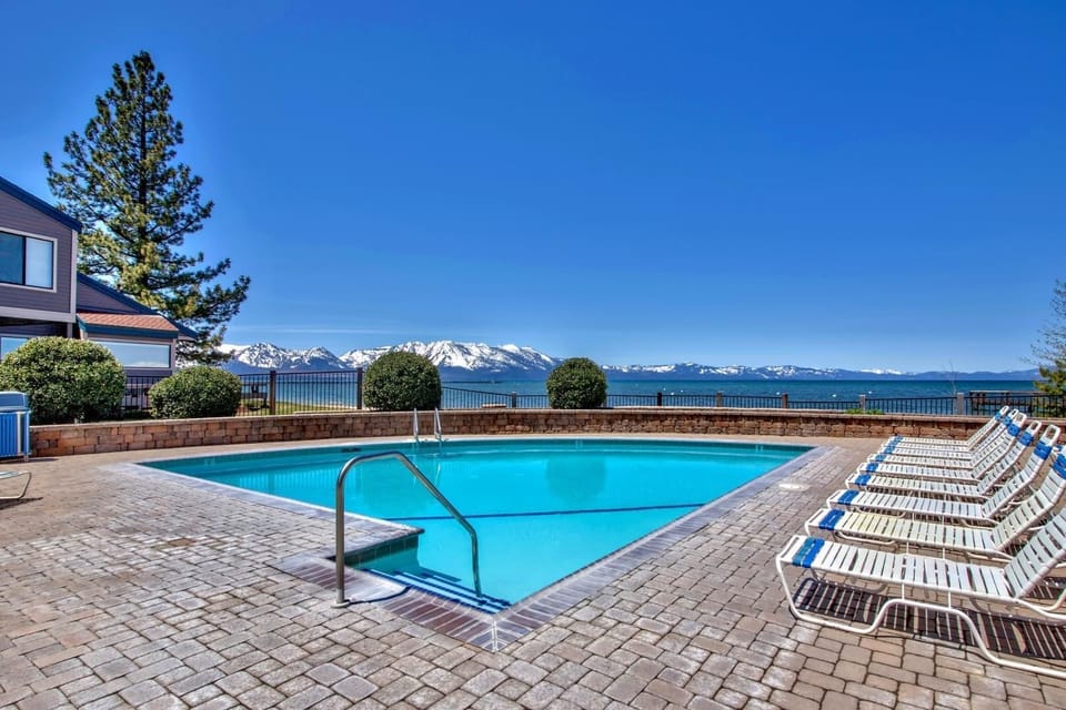 Stunning mountain views frame this sparkling pool area with comfortable loungers for your perfect alpine getaway.