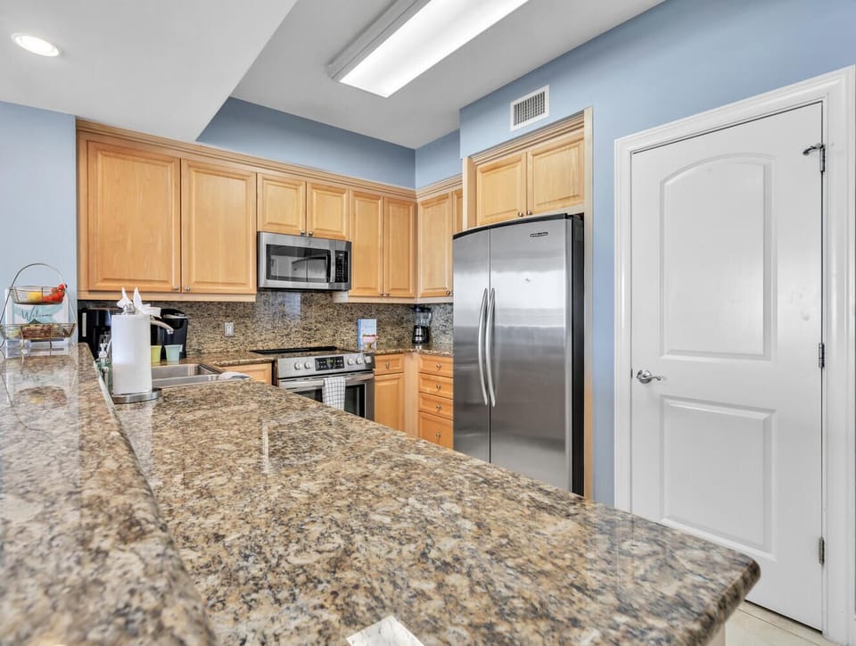 Your fully equipped kitchen features granite counters, stainless appliances, and warm wood cabinets for memorable meal prep.