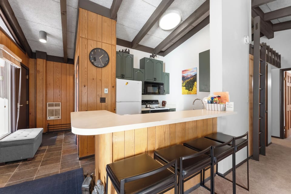 Gather around this stunning kitchen island where warm wood meets modern style, perfect for morning coffee or evening conversations.