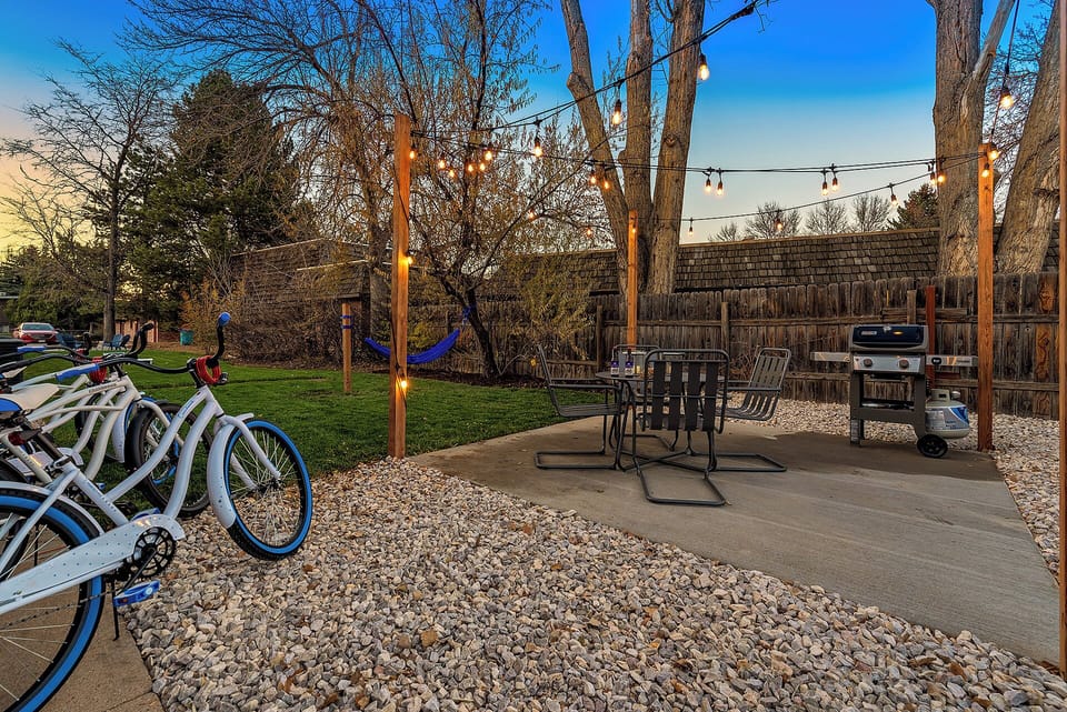 Backyard | String Lights, BBQ Grill, and Outdoor Dining Area | Cruiser bicycles available for your use!