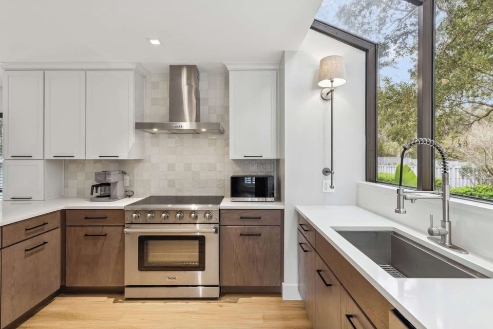 The sleek, airy kitchen offers ample space & every home comfort