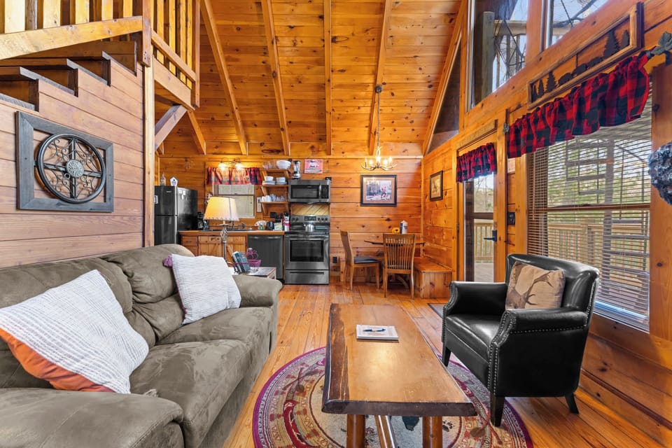 Living area with electric fireplace, TV, and cozy seating 