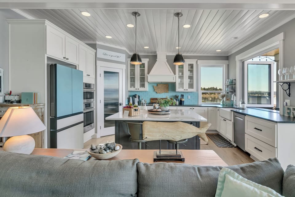 Bright coastal kitchen with island seating and stylish open-concept design