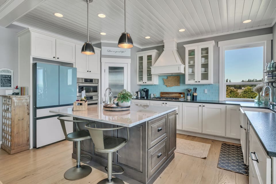 Bright designer kitchen with large island seating and abundant natural light