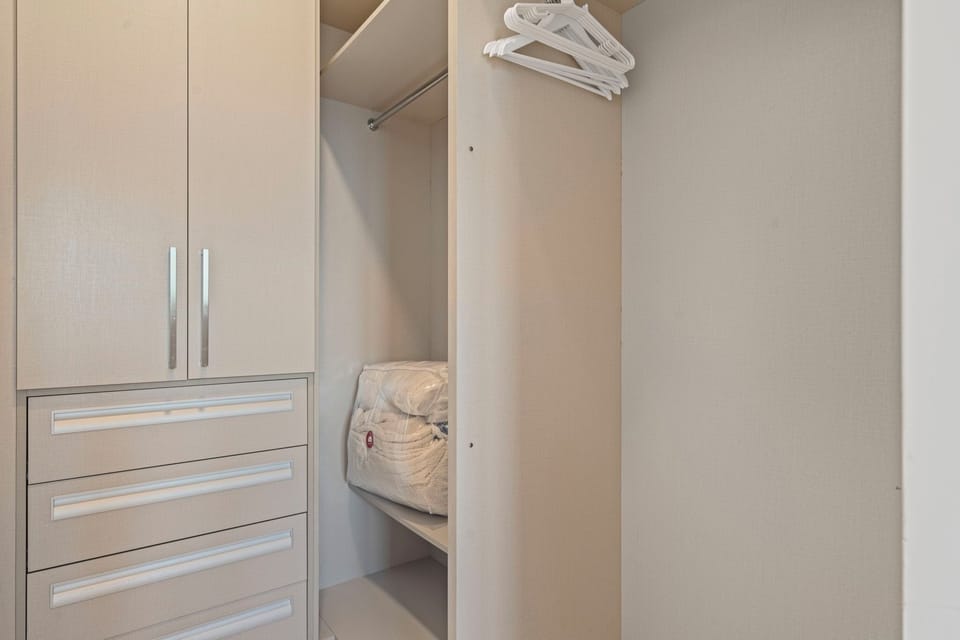 Spacious walk in closet with plenty of storage to keep your belongings organized - Equipped with hangers, drawers, and an iron to keep you looking your best - No need to live out of a suitcase, settle in and enjoy your stay