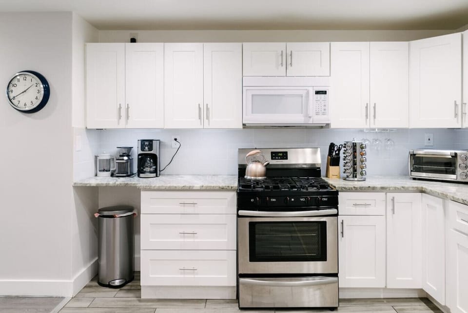 Kitchen is equipped with a microwave, toaster oven, gas stovetop and oven, spices, knives, coffee, burr grinder, french press, and more.