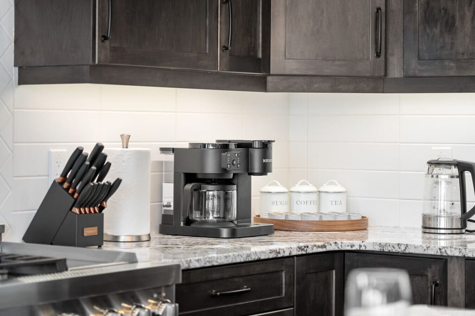 Well-equipped kitchen featuring granite counters and modern appliances