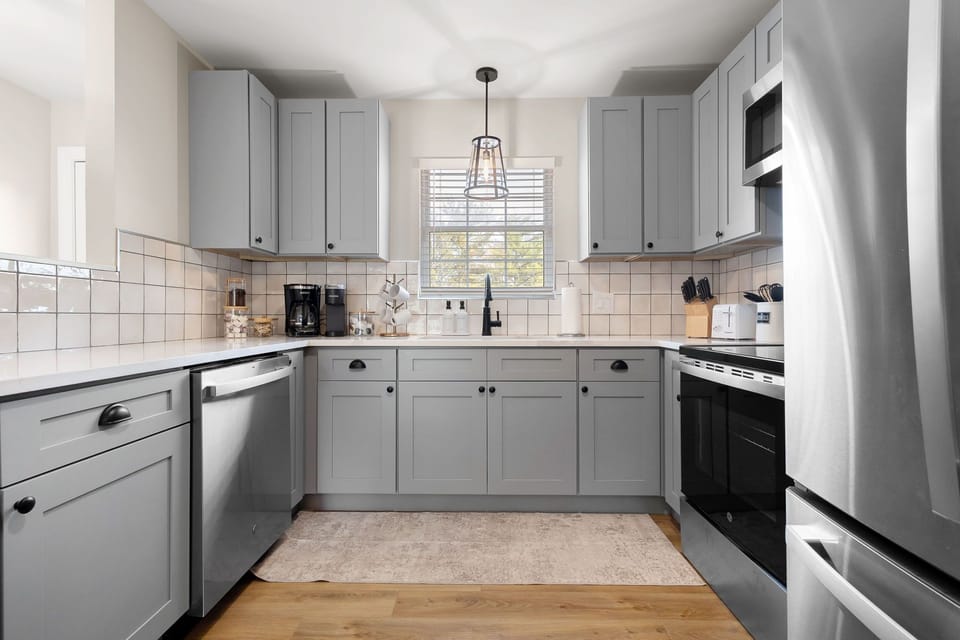 A kitchen that has it all -- coffee station, cookware, silverware, dinnerware.