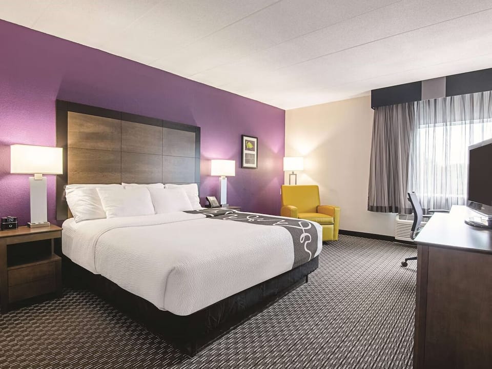 Relax in a roomy king retreat with daylight by the window.
