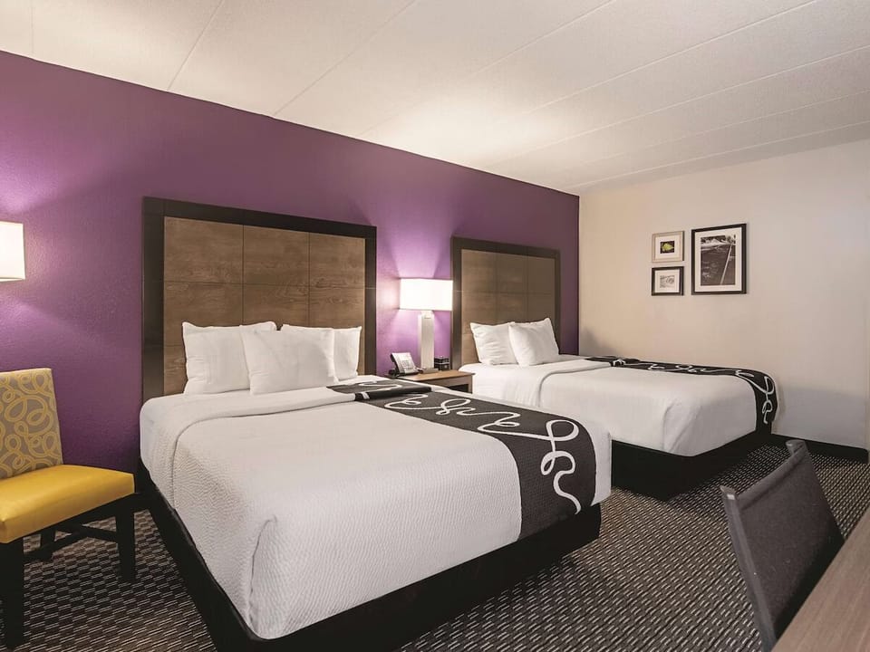 Unwind in crisp linens with a cozy two-bed retreat.