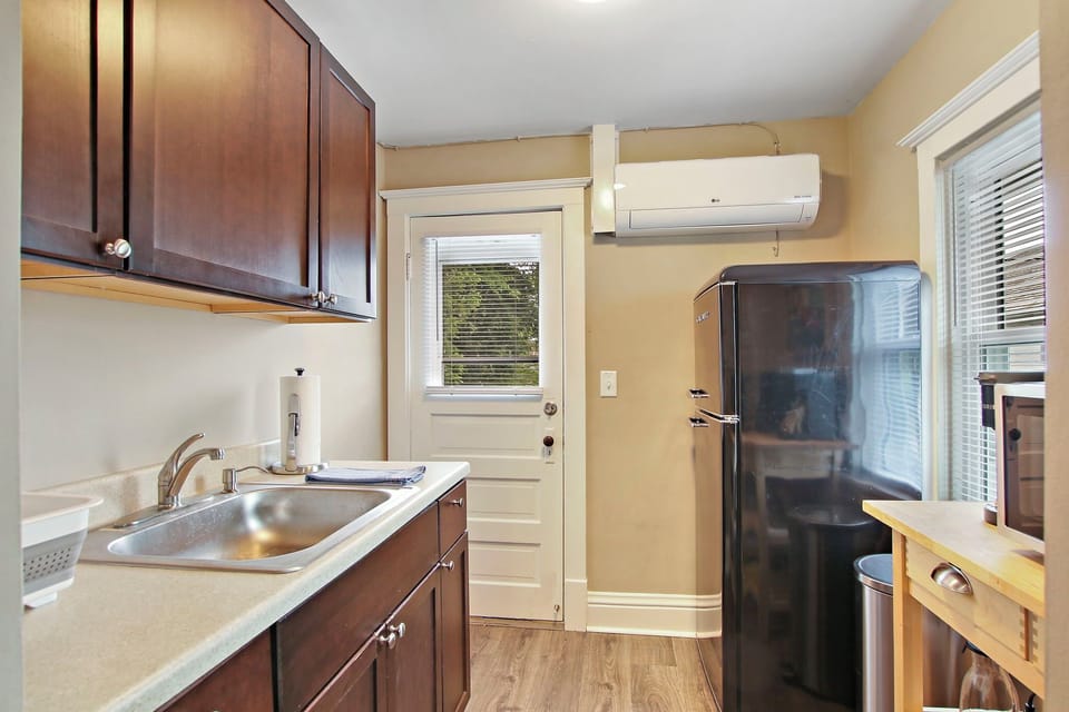 Kitchenette set-up, no stove but microwave, door to shared balcony