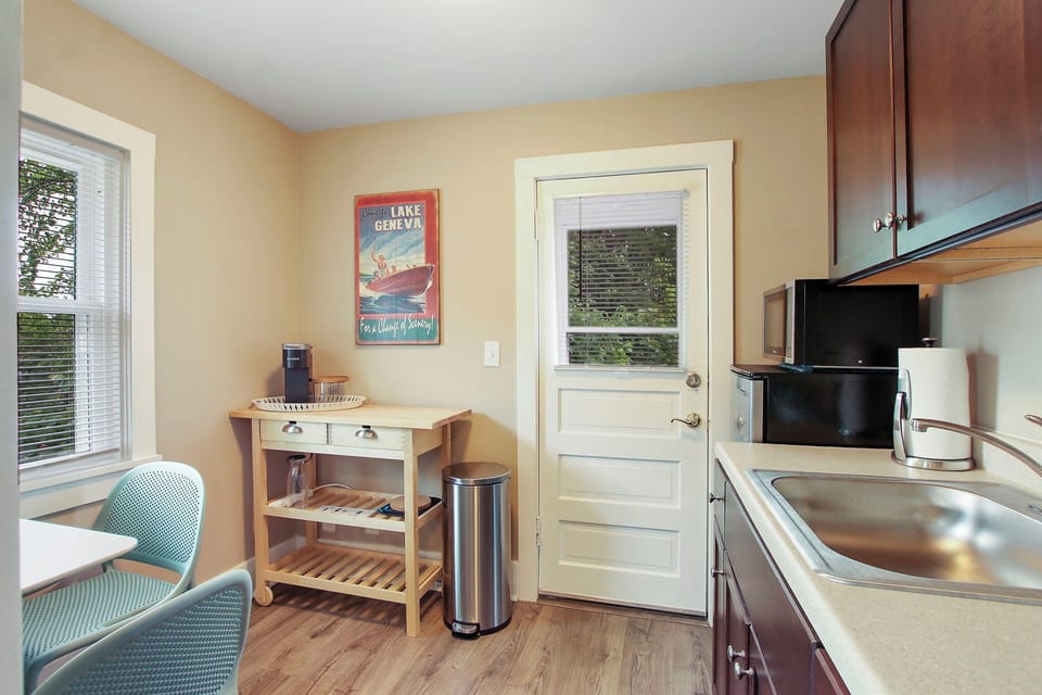 Kitchenette set-up (no stove) opening up to shared balcony