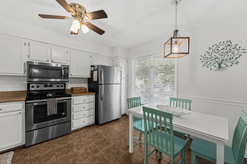 The kitchen features sleek stainless steel appliances and granite countertops.