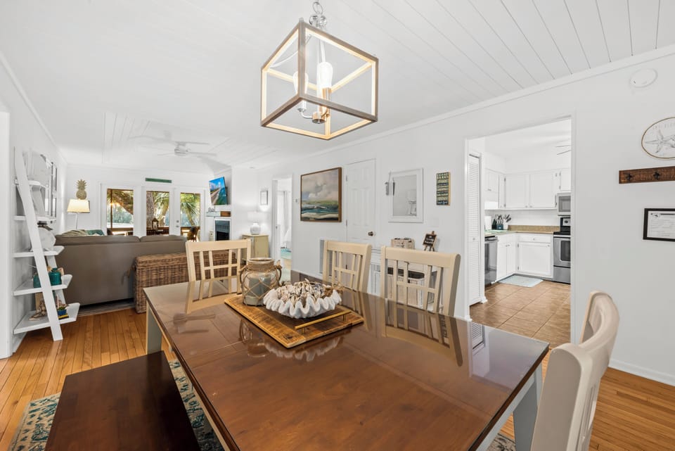 The dining table offers comfortable seating for 7 for family meals.