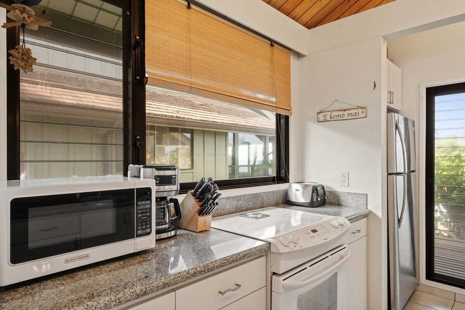 Fully equipped kitchen with granite countertops, stainless appliances, and modern cabinetry—ready for home‑cooked meals.