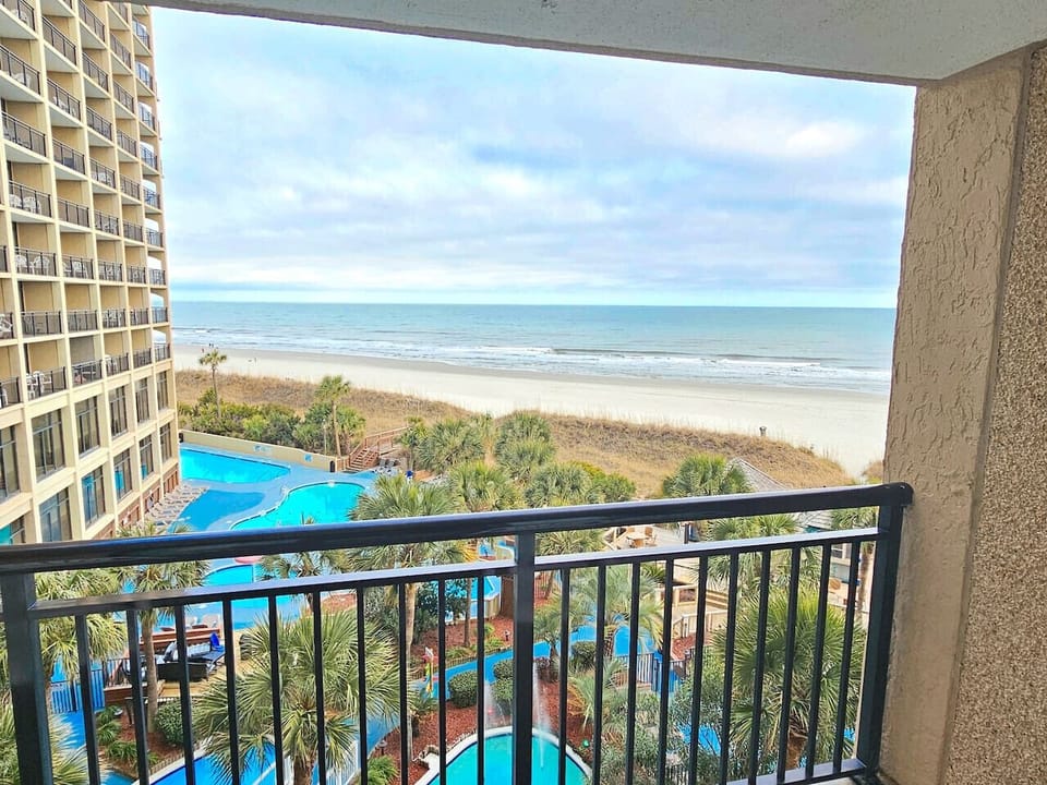 Balcony View with Seasonally Heated Pools,  Hot tubs, and Tropical Theme
