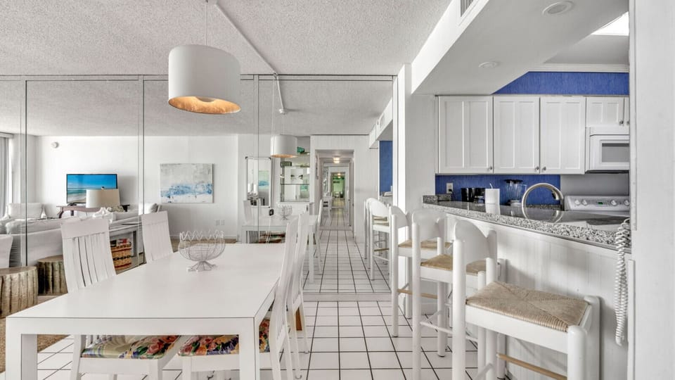 Sitting available at the kitchen bar or the dining room table.