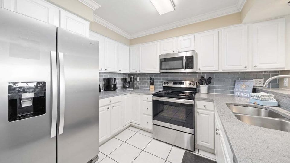 Fully Equipped Kitchen. Enjoy the convenience of stainless steel appliances, granite countertops, and all the essentials you need for home-cooked meals or beachside snacks.