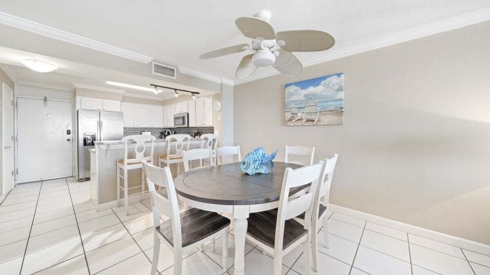 Dining Area. Bright and welcoming space with seating for six, perfect for family meals or game nights near the kitchen and bar seating.