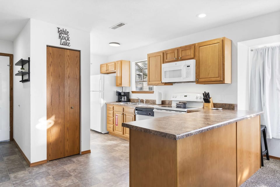The open, airy kitchen offers ample space & every home comfort